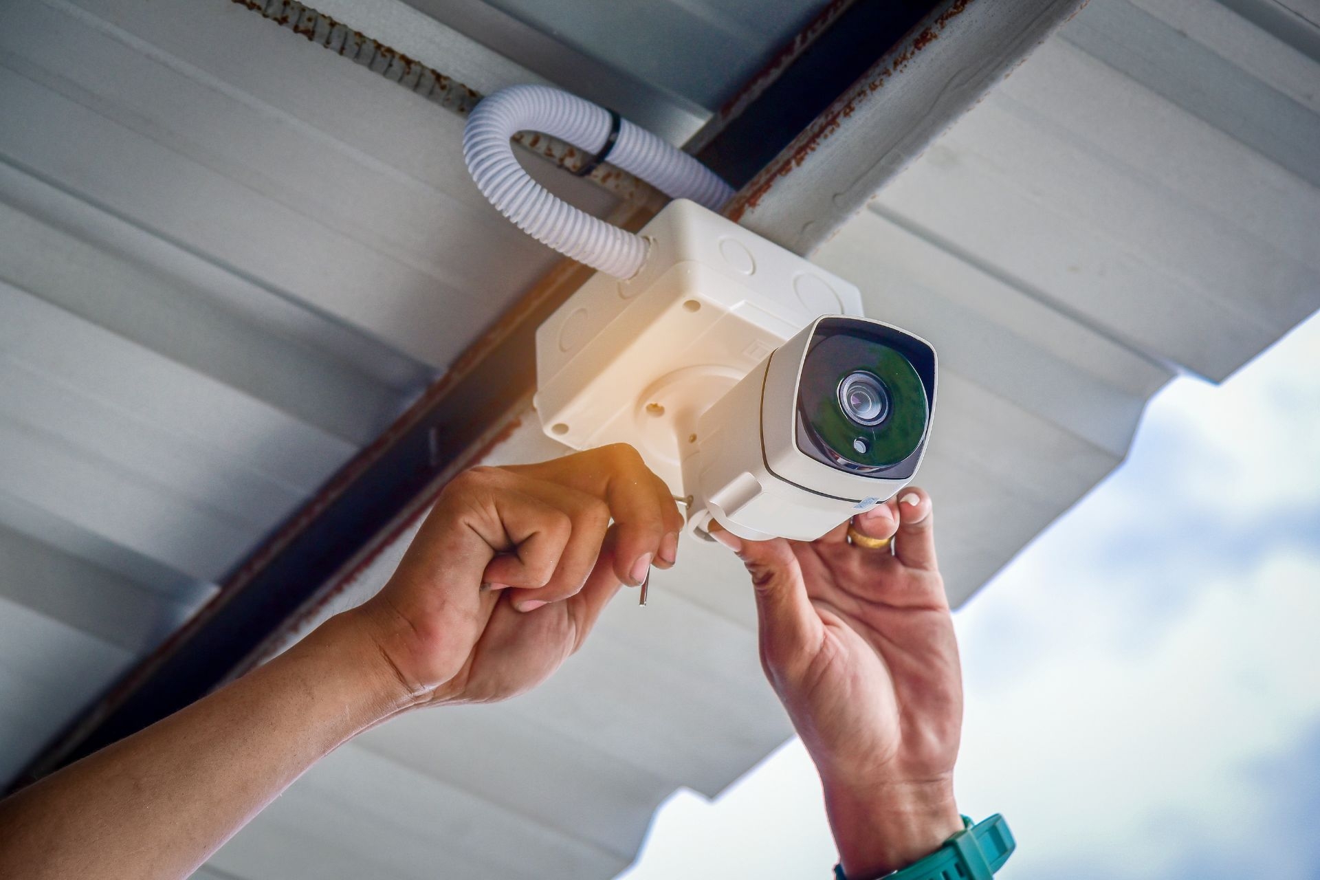 What are some common challenges or issues faced when implementing and maintaining surveillance cameras at the entrance of an apartment complex?